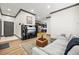 Open-concept living space showcasing a sectional sofa, media center, and a seamless transition to the modern kitchen at 8453 Charleston Hwy, Walterboro, SC 29488