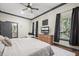 This spacious main bedroom has a ceiling fan, neutral colored walls, and an ensuite bath at 8453 Charleston Hwy, Walterboro, SC 29488