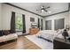 Spacious main bedroom with hardwood floors, a ceiling fan, a dresser, and neutral colored walls at 8453 Charleston Hwy, Walterboro, SC 29488