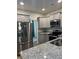 Modern kitchen with granite countertops and stainless steel appliances at 9410 Sweep Dr, Summerville, SC 29485