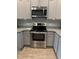 Stainless steel range and microwave compliment grey kitchen cabinets at 9410 Sweep Dr, Summerville, SC 29485