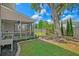 Landscaped backyard featuring a screened porch, patio area and a beautiful mature shade tree at 9682 Pebble Creek Blvd, Summerville, SC 29485