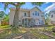 Expansive backyard featuring a screened porch, mature trees, and a charming fire pit area for outdoor relaxation at 9682 Pebble Creek Blvd, Summerville, SC 29485