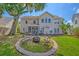 Spacious backyard featuring a fire pit area, mature trees, and manicured landscaping, perfect for entertaining at 9682 Pebble Creek Blvd, Summerville, SC 29485