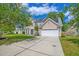 Well-maintained two-story home with a spacious driveway and attached garage for convenient parking at 9682 Pebble Creek Blvd, Summerville, SC 29485
