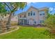 Home's exterior showing a large yard, trees and screened porch and fire pit area at 9682 Pebble Creek Blvd, Summerville, SC 29485