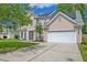 Inviting home exterior with a two-car garage, solar panels, and a well-maintained lawn with manicured landscaping at 9682 Pebble Creek Blvd, Summerville, SC 29485