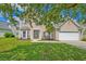 Charming two-story home with manicured lawn, mature tree, and attached garage at 9682 Pebble Creek Blvd, Summerville, SC 29485