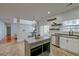 Spacious kitchen boasts tile floors, gray cabinets, stainless appliances and an island with bar seating at 9682 Pebble Creek Blvd, Summerville, SC 29485