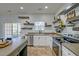 Bright kitchen features stainless appliances, floating shelves, tile floors and access to back yard at 9682 Pebble Creek Blvd, Summerville, SC 29485