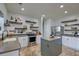 Open kitchen with stainless steel appliances, island, and decorative shelves at 9682 Pebble Creek Blvd, Summerville, SC 29485