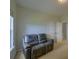 A cozy living room features a comfortable grey couch and a view of the open doorway at 9682 Pebble Creek Blvd, Summerville, SC 29485