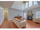 Spacious living room featuring a fireplace, neutral tones, and high ceilings at 9682 Pebble Creek Blvd, Summerville, SC 29485