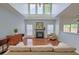 This inviting living room offers soaring ceilings, fireplace, beautiful hardwood floors and lots of natural light at 9682 Pebble Creek Blvd, Summerville, SC 29485