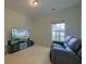 Living room featuring a large TV, comfortable seating and natural light from the window at 9682 Pebble Creek Blvd, Summerville, SC 29485