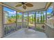 Cozy screened porch with ceiling fan and view to the backyard's patio area and attractive landscaping at 9682 Pebble Creek Blvd, Summerville, SC 29485
