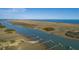 Scenic aerial view of waterway with private docks and lush coastline, showcasing coastal beauty at 0 Doar Rd, Awendaw, SC 29429
