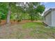 Spacious, green backyard featuring a privacy fence, mature trees, and a well-maintained lawn at 1 Bossis Dr, Charleston, SC 29407