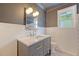 This updated bathroom offers a modern vanity, decorative mirror, and stylish geometric floor tiles at 1 Bossis Dr, Charleston, SC 29407