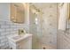 Modern bathroom features a patterned-tile shower, and a vanity with gold hardware at 1 Bossis Dr, Charleston, SC 29407
