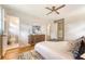 Spacious bedroom with hardwood floors, ceiling fan, and ensuite bathroom at 1 Bossis Dr, Charleston, SC 29407