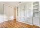 Bedroom featuring built-in Murphy bed and storage with hardwood floors and natural light at 1 Bossis Dr, Charleston, SC 29407