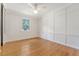 A stylish bedroom features wood floors, a ceiling fan, and board and batten accent wall at 1 Bossis Dr, Charleston, SC 29407
