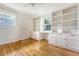 A sunlit bedroom includes built-in cabinets and shelving for ample storage and display at 1 Bossis Dr, Charleston, SC 29407