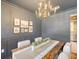 Elegant dining room featuring gray walls, wood trim, and a gold chandelier at 1 Bossis Dr, Charleston, SC 29407
