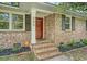 Inviting front entrance showcasing brick steps and a red door with sidelight windows, adding curb appeal at 1 Bossis Dr, Charleston, SC 29407