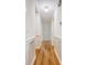 Bright hallway features hardwood floors, white wainscoting, and paneled doors at 1 Bossis Dr, Charleston, SC 29407