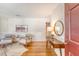 Bright, stylish living room featuring hardwood floors, wainscotting, and elegant decor with warm natural light at 1 Bossis Dr, Charleston, SC 29407