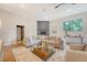 Cozy living room with a modern fireplace, comfortable seating, and a large window with backyard view at 1 Bossis Dr, Charleston, SC 29407