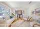 Bright living room with hardwood floors and white wainscotting, open to a dining area at 1 Bossis Dr, Charleston, SC 29407