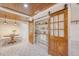 Large walk-in pantry with wooden sliding doors, shelving, and wood plank ceiling at 1 Bossis Dr, Charleston, SC 29407
