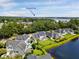An aerial view with Shipyard Park in the distance, close to houses with solar panels and pond at 1003 Jervey Point Rd, Wando, SC 29492
