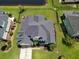 Aerial view of a single-Gathering home with a well-manicured lawn, a dark gray roof and backyard pond at 1003 Jervey Point Rd, Wando, SC 29492