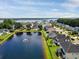 This aerial view showcases the neighborhood and the pond featuring a water fountain at 1003 Jervey Point Rd, Wando, SC 29492