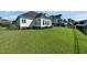 Well-maintained backyard with a lush green lawn, shrubs, and home exterior at 1003 Jervey Point Rd, Wando, SC 29492