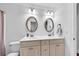 Bright bathroom with dual sinks, white cabinets, framed mirrors, and neutral paint for a clean, modern look at 1003 Jervey Point Rd, Wando, SC 29492