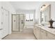 Bathroom with neutral colored cabinetry, tiled floors, shower and separate soaking tub at 1003 Jervey Point Rd, Wando, SC 29492