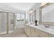 Bathroom with neutral colored cabinetry, tiled floors, shower and separate soaking tub at 1003 Jervey Point Rd, Wando, SC 29492