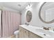 Bathroom featuring dual sinks, tile floors, framed mirrors, and neutral paint, accented with a shower and curtain at 1003 Jervey Point Rd, Wando, SC 29492