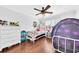bedroom with white dresser, wood floors and large window with white shutters for natural light at 1003 Jervey Point Rd, Wando, SC 29492