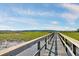 Scenic boardwalk view with lush green marshland and clear blue sky at 1003 Jervey Point Rd, Wando, SC 29492
