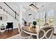 Light-filled dining room featuring hardwood floors, staircase, and decorative accents at 1003 Jervey Point Rd, Wando, SC 29492