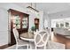 Bright dining room with modern lighting, hardwood floors, and views into the living room at 1003 Jervey Point Rd, Wando, SC 29492