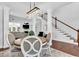 Open-concept dining area with hardwood floors, staircase, and views into the living room at 1003 Jervey Point Rd, Wando, SC 29492