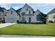 Charming two-story home with manicured lawn and a two-car garage at 1003 Jervey Point Rd, Wando, SC 29492