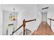 Bright hallway with hardwood floors and white wainscotting leading to the home's entry and featuring a chandelier at 1003 Jervey Point Rd, Wando, SC 29492